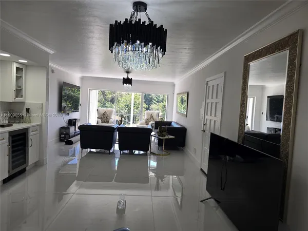 a living room with furniture or chandelier and a dining table