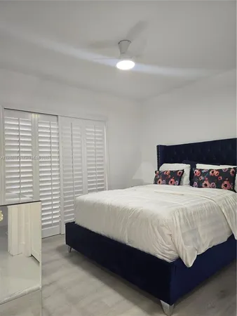 a bedroom with a bed and window