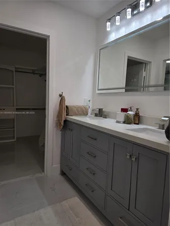 a bathroom with a double vanity sink and mirror