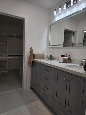 a view of a swimming pool with a table and chairs under an umbrella
