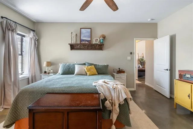 a bed sitting in a bedroom next to a window