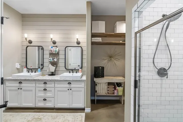 a bathroom with a double vanity sink and a mirror
