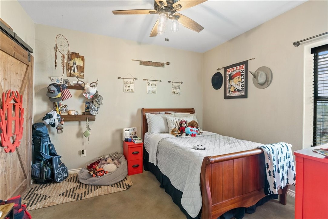 226 Private Road Alice, TX 78332 - Photo 22 of 40 a bedroom with a bed and a chandelier