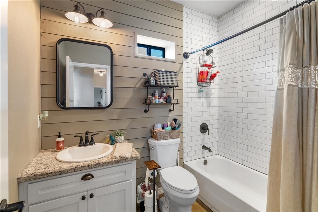 226 Private Road Alice, TX 78332 - Photo 24 of 40 a bathroom with a granite countertop toilet sink and mirror
