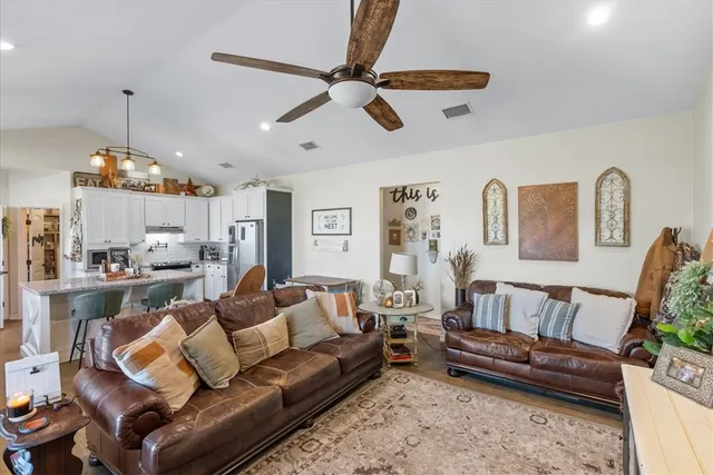 a living room with furniture and a chandelier