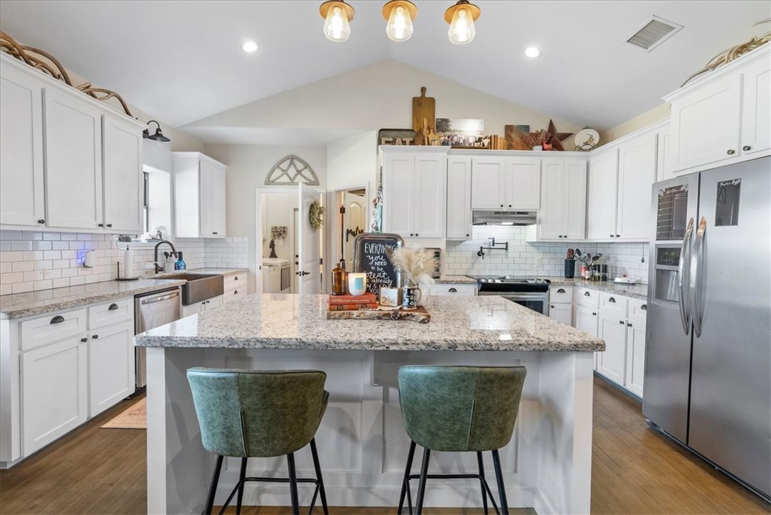 226 Private Road Alice, TX 78332 - Photo 7 of 40 a kitchen with stainless steel appliances granite countertop a sink a stove a refrigerator cabinets and chairs