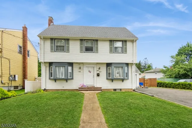 a front view of a house with a yard and porch