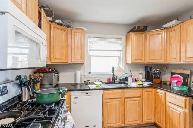a kitchen with a sink cabinets and window