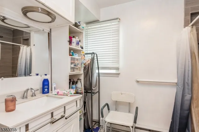 a bathroom with a sink vanity granite and a mirror