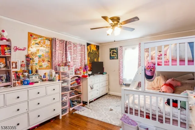 a bedroom with furniture a baby bed baby crib and a window