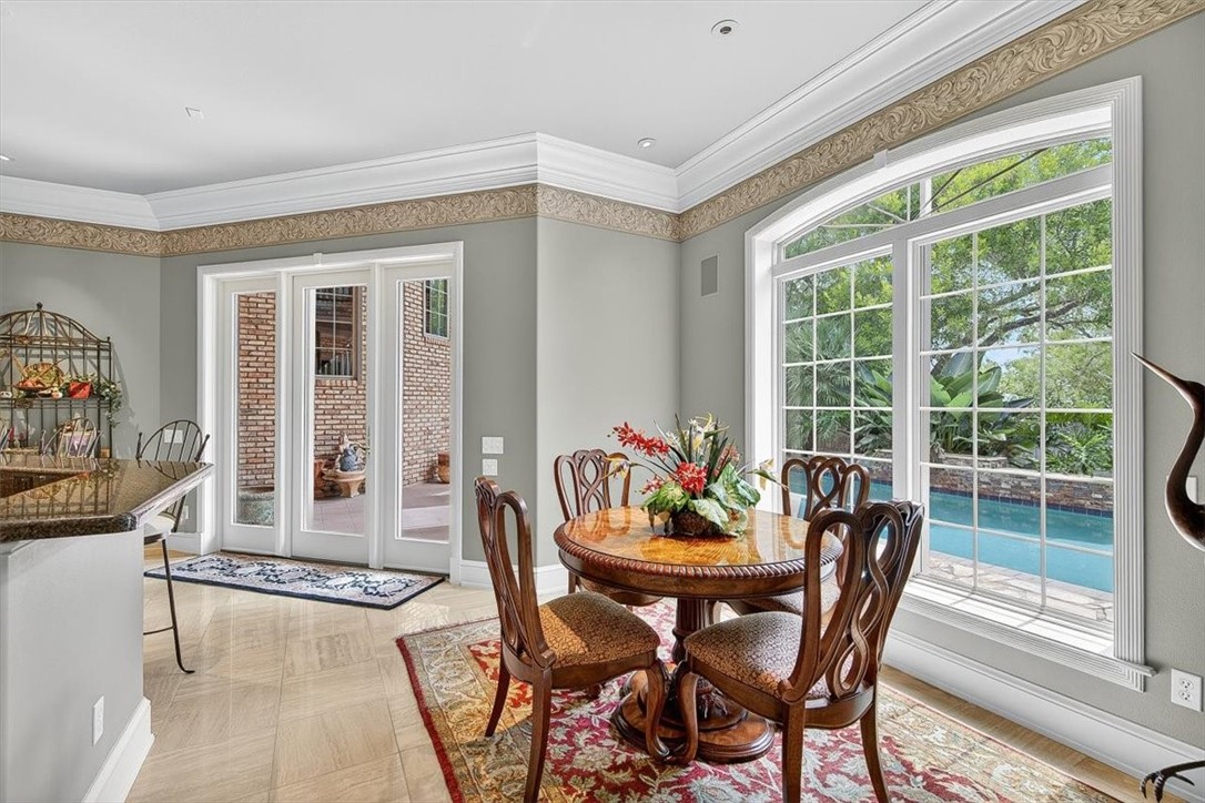 4811 Ocean Drive Corpus Christi, TX 78412 - Photo 11 of 39 a dining room with furniture a rug and a potted plant
