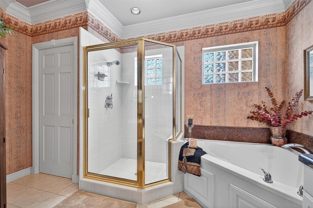 4811 Ocean Drive Corpus Christi, TX 78412 - Photo 24 of 39 a bathroom with a tub shower and window