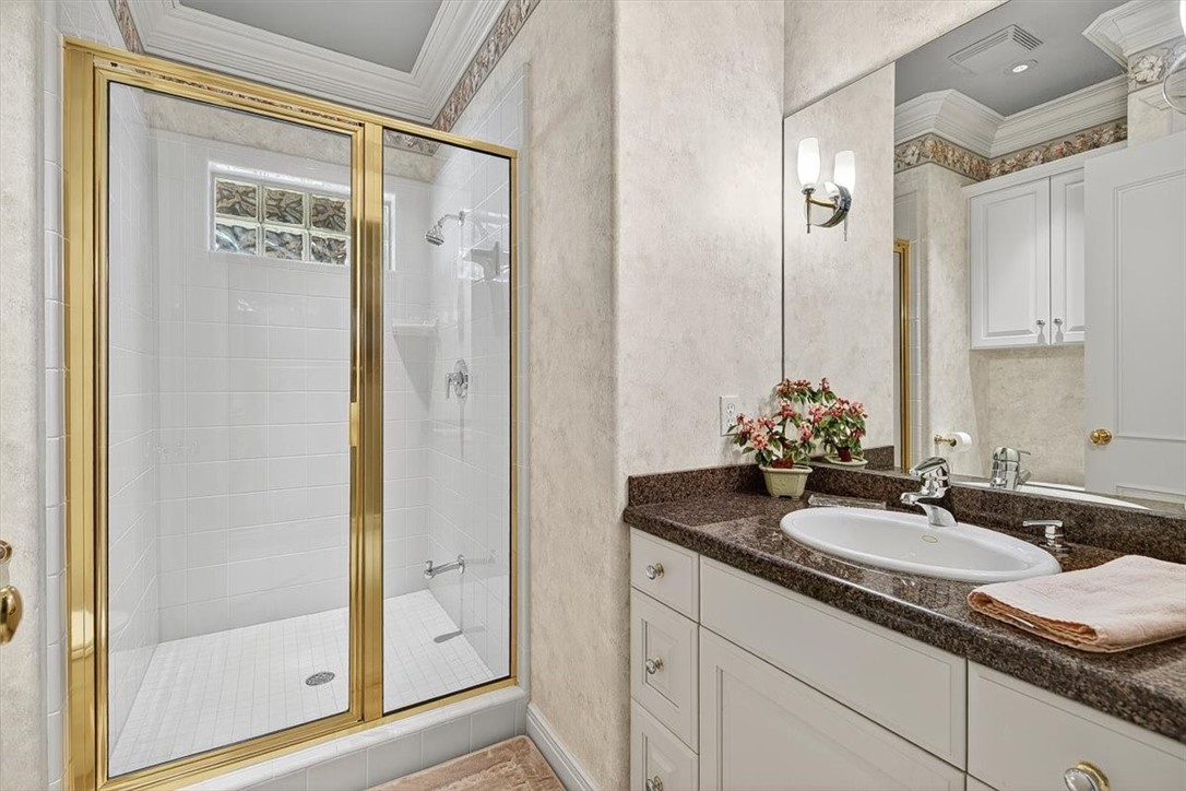 4811 Ocean Drive Corpus Christi, TX 78412 - Photo 28 of 39 a bathroom with a granite countertop sink and a mirror