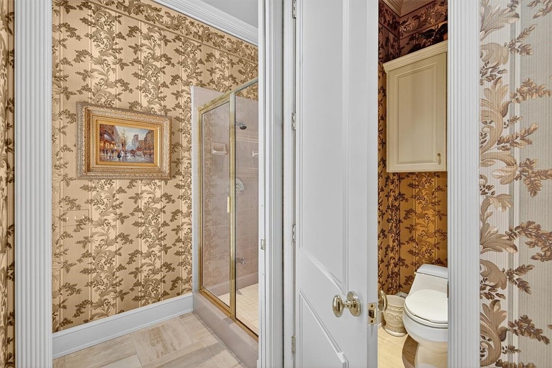 4811 Ocean Drive Corpus Christi, TX 78412 - Photo 30 of 39 view of a bathroom with a toilet and a shower curtain