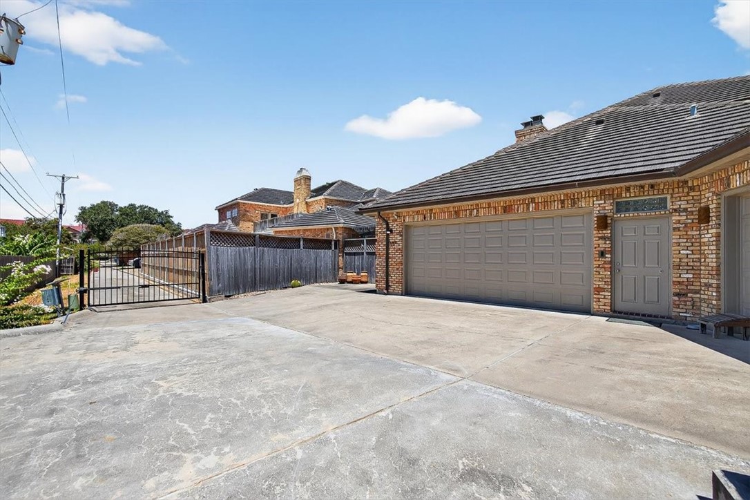 4811 Ocean Drive Corpus Christi, TX 78412 - Photo 37 of 39 a front view of a house with a yard and garage