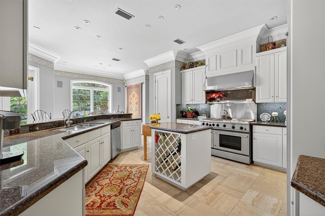 4811 Ocean Drive Corpus Christi, TX 78412 - Photo 8 of 39 a kitchen with a stove sink and cabinets