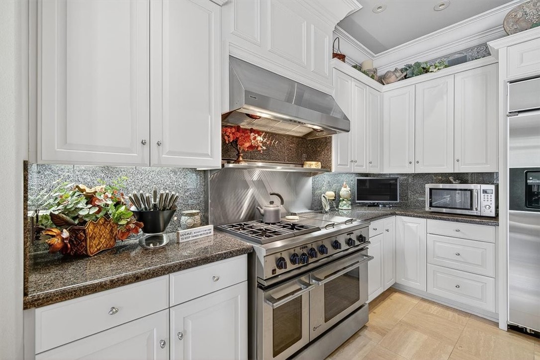 4811 Ocean Drive Corpus Christi, TX 78412 - Photo 10 of 39 a kitchen with white cabinets and appliances