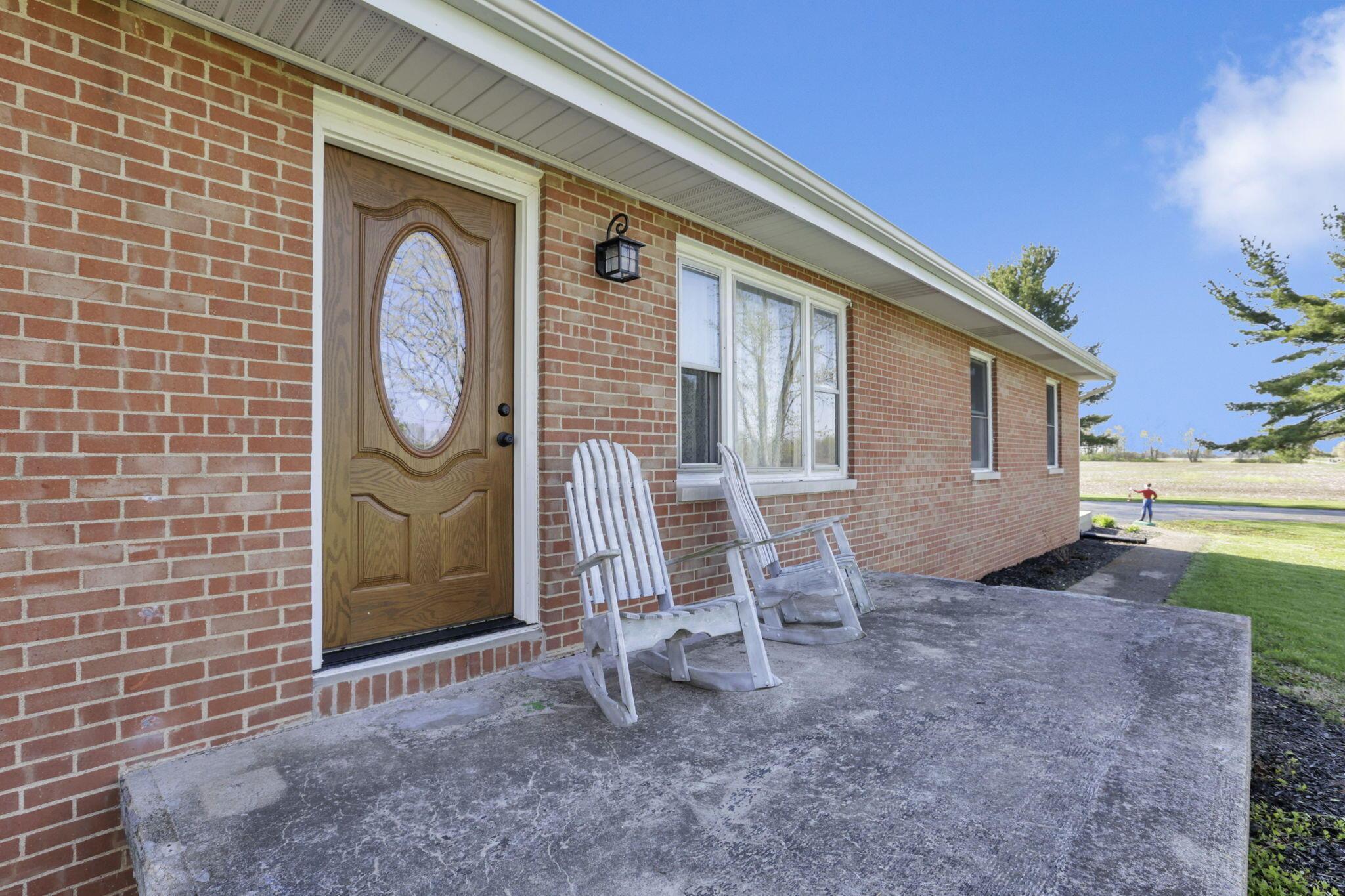 7974 Braun Road Groveport, OH 43125 - Photo 5 of 29 Brick exterior with a wooden entry door featuring an oval glass insert