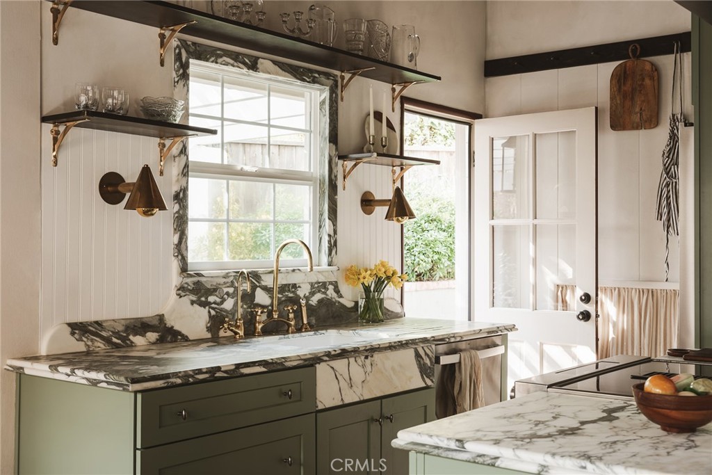601 Sinclair Avenue Glendale, CA 91206 - Photo 11 of 38 a kitchen with a granite countertop sink window and cabinets