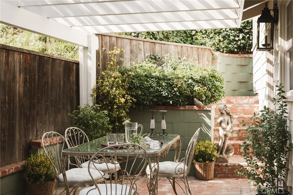 601 Sinclair Avenue Glendale, CA 91206 - Photo 15 of 38 a backyard of a house with table and chairs potted plants