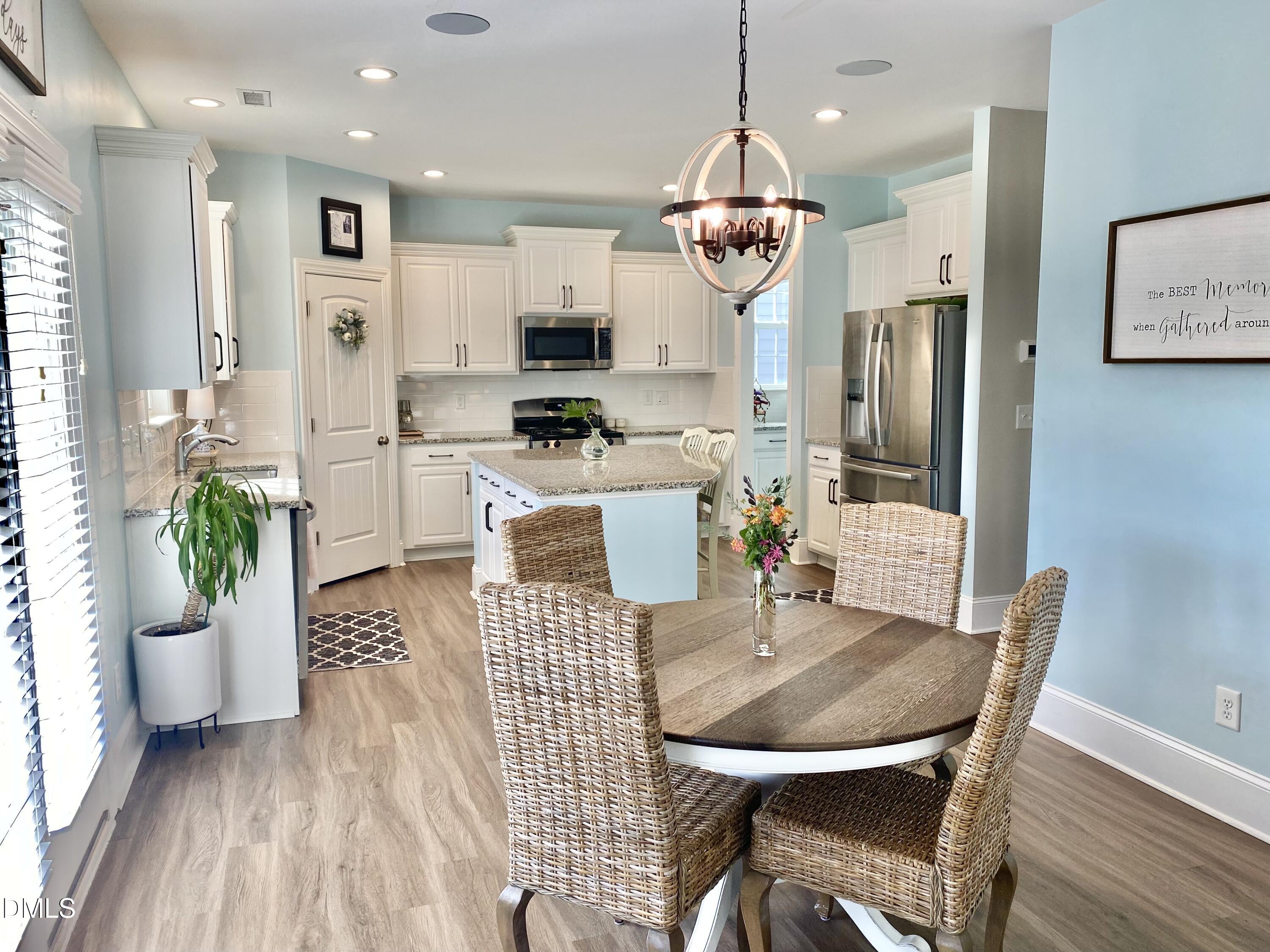 2913 Thurman Dairy Loop Wake Forest, NC 27587 - Photo 11 of 31 a view of a dining room and livingroom with furniture wooden floor a chandelier