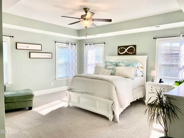 a dining room with furniture a chandelier and wooden floor
