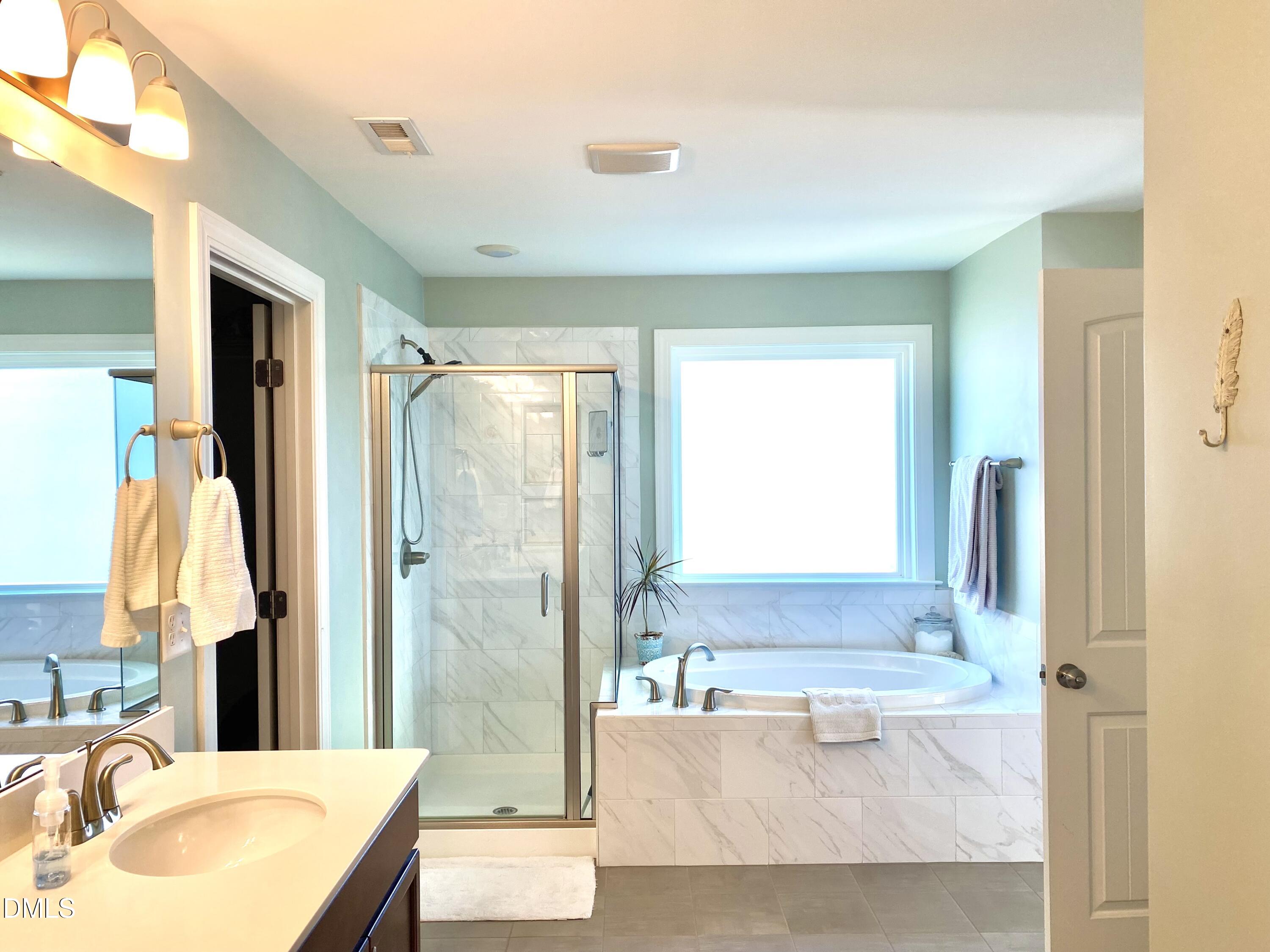 2913 Thurman Dairy Loop Wake Forest, NC 27587 - Photo 16 of 31 a bathroom with a bathtub sink and mirror