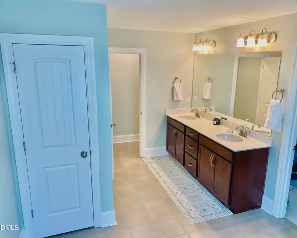 a bathroom with a bathtub sink and mirror