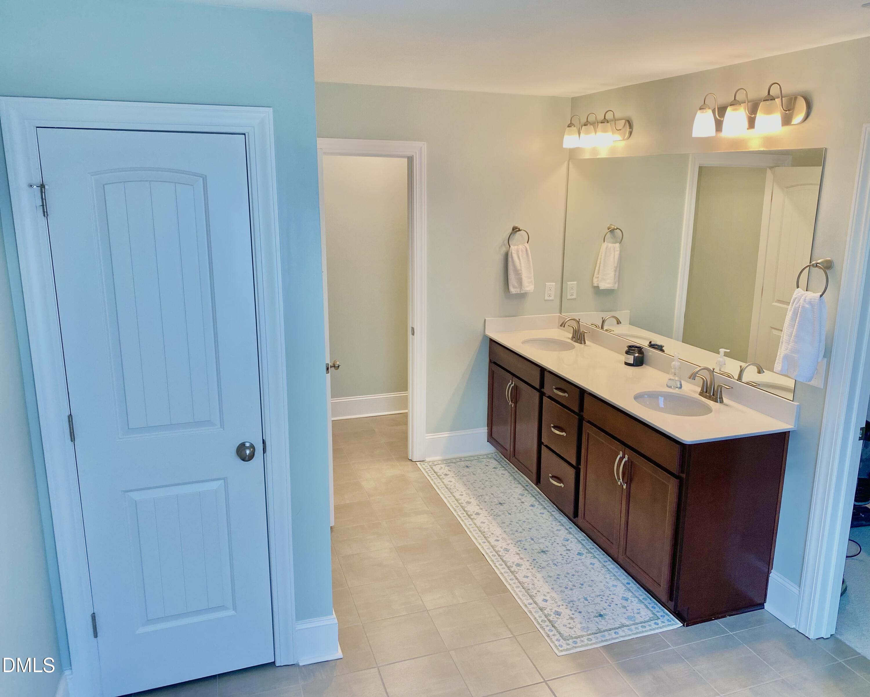 2913 Thurman Dairy Loop Wake Forest, NC 27587 - Photo 17 of 31 a bathroom with a double vanity sink and a mirror