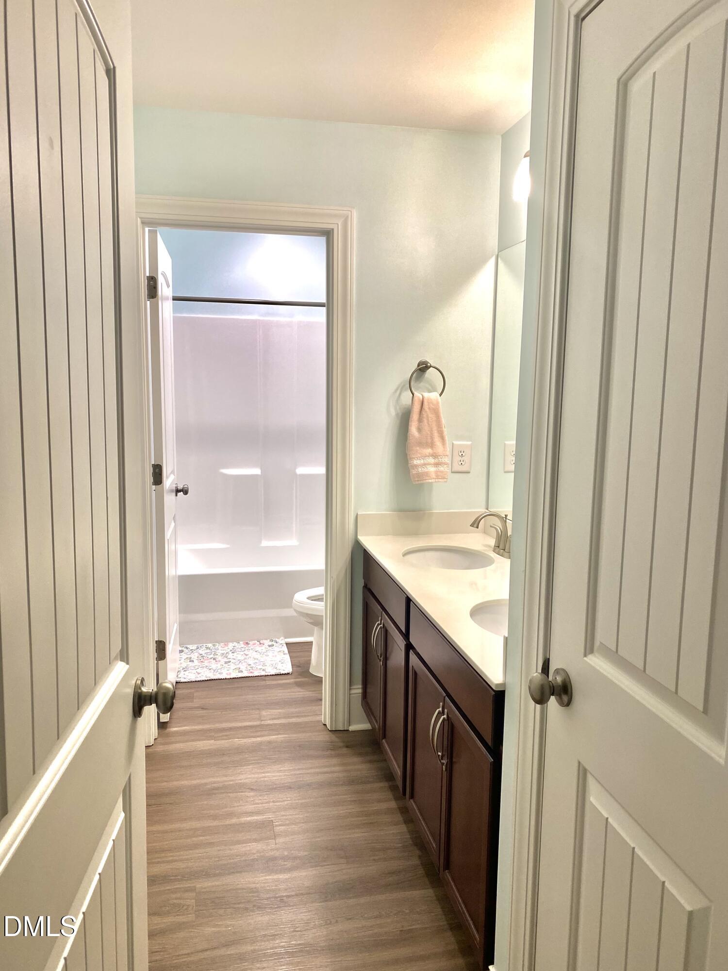 2913 Thurman Dairy Loop Wake Forest, NC 27587 - Photo 20 of 31 a bathroom with a granite countertop sink and a mirror