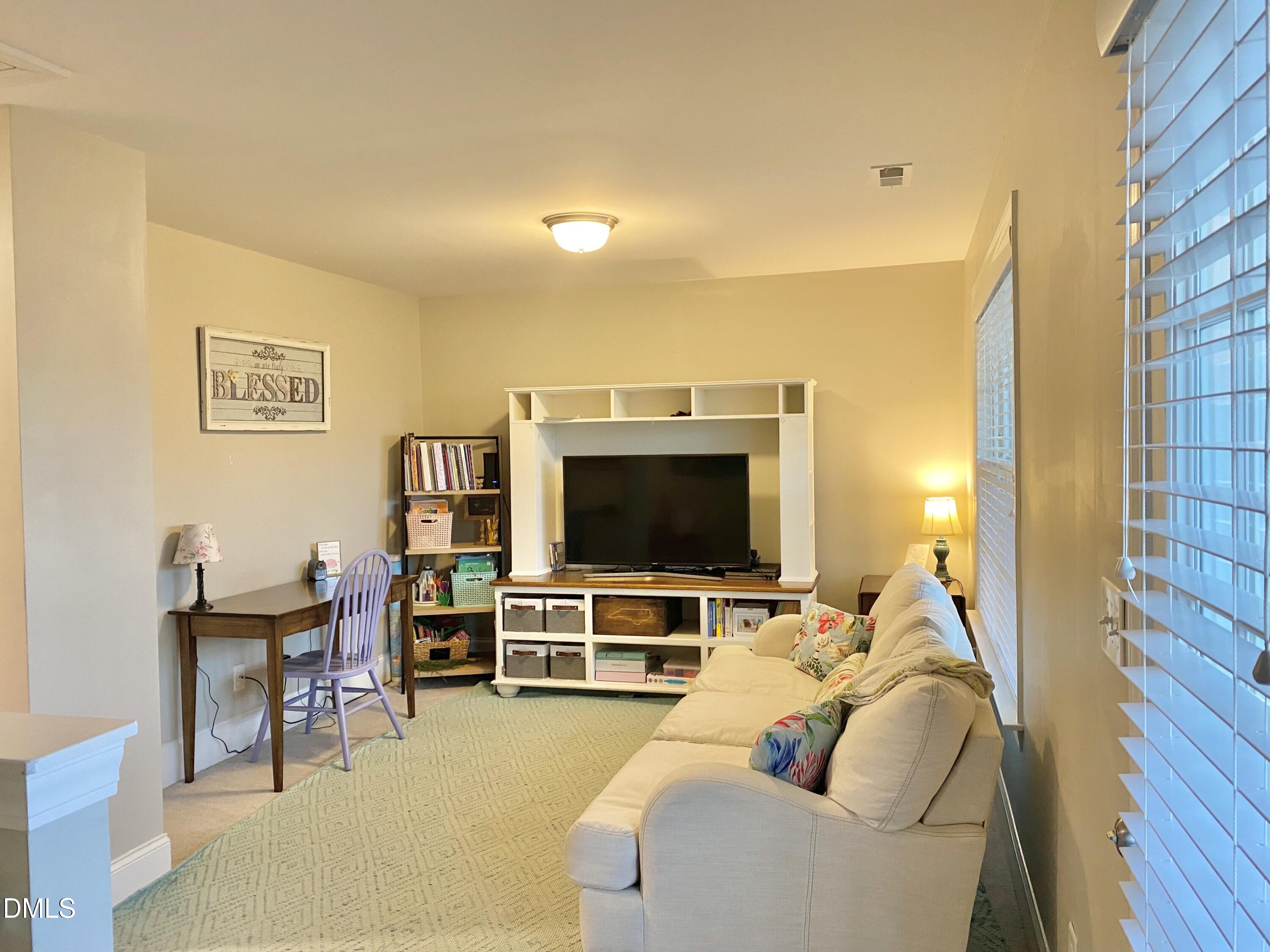 2913 Thurman Dairy Loop Wake Forest, NC 27587 - Photo 22 of 31 a living room with furniture and a flat screen tv
