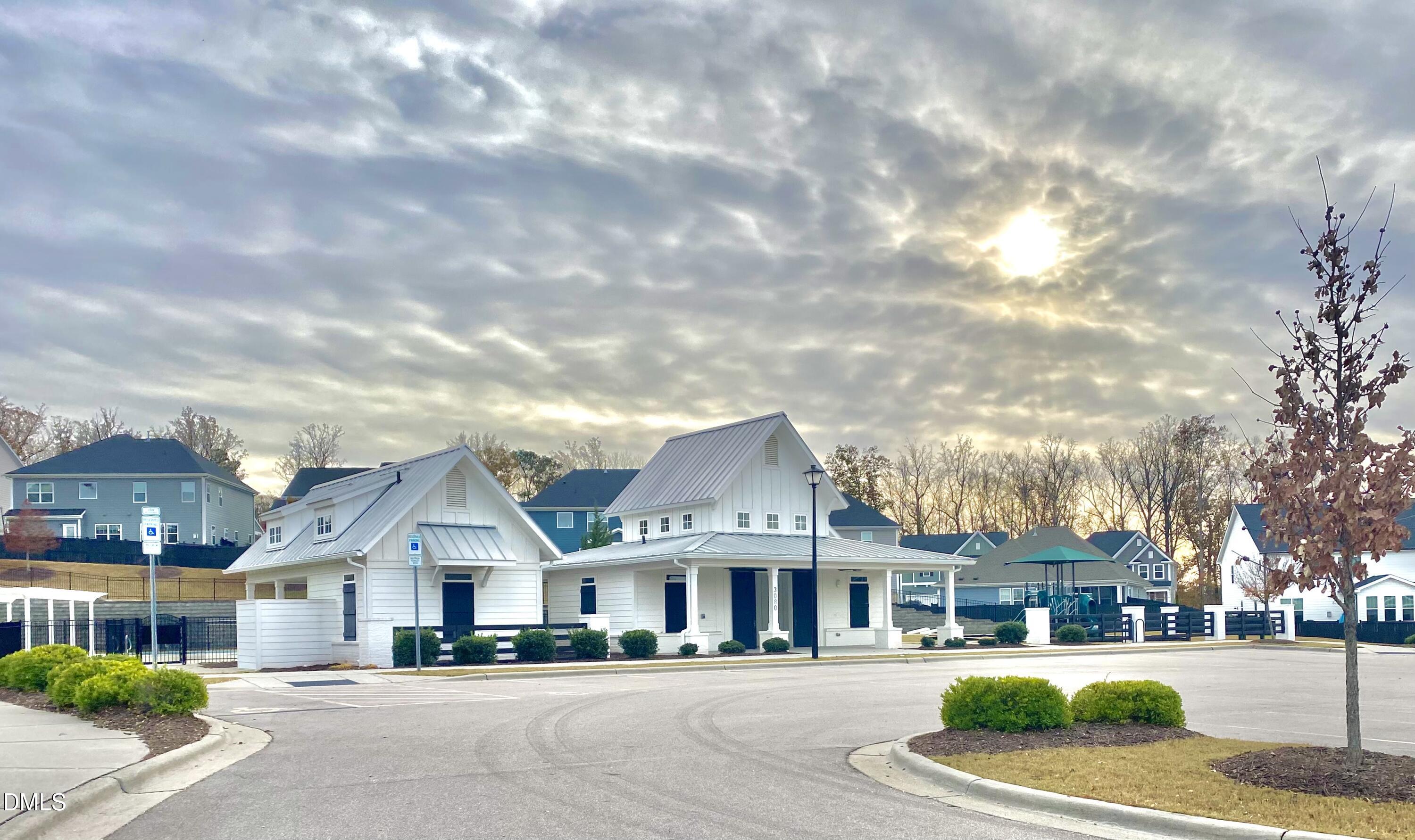 2913 Thurman Dairy Loop Wake Forest, NC 27587 - Photo 27 of 31 a front view of a building with lot of cars and trees