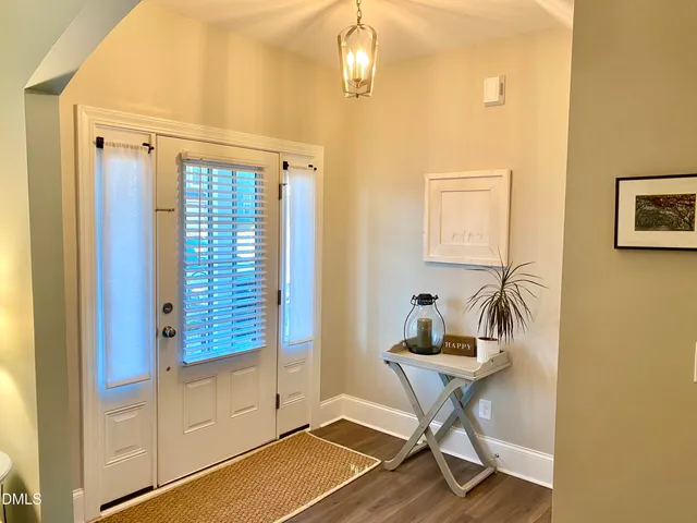 a view of a balcony with chair and floor to ceiling window