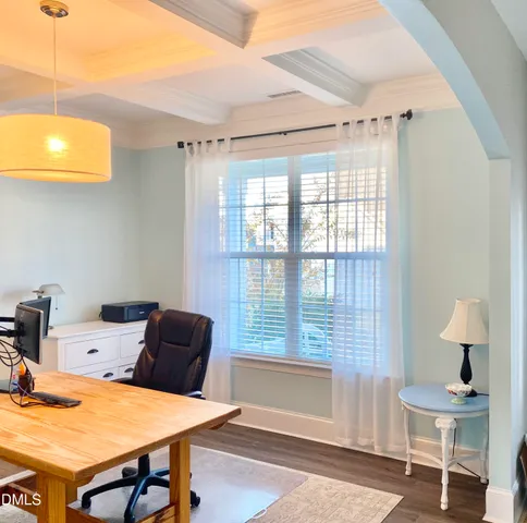 a view of a dining room with a table and chairs