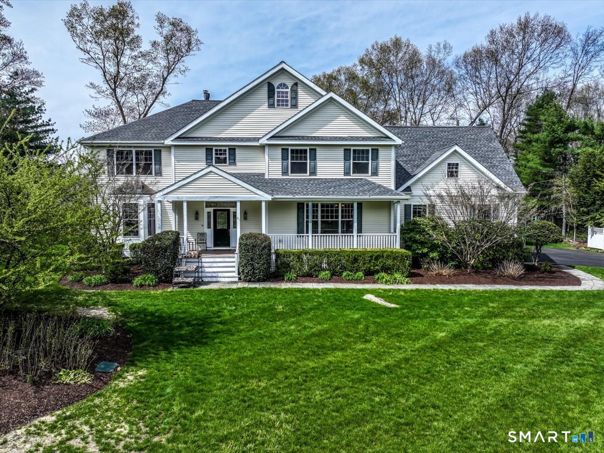 21 Pearl Street Newtown, CT 06482 - Photo 1 of 39 a front view of a house with a garden and trees