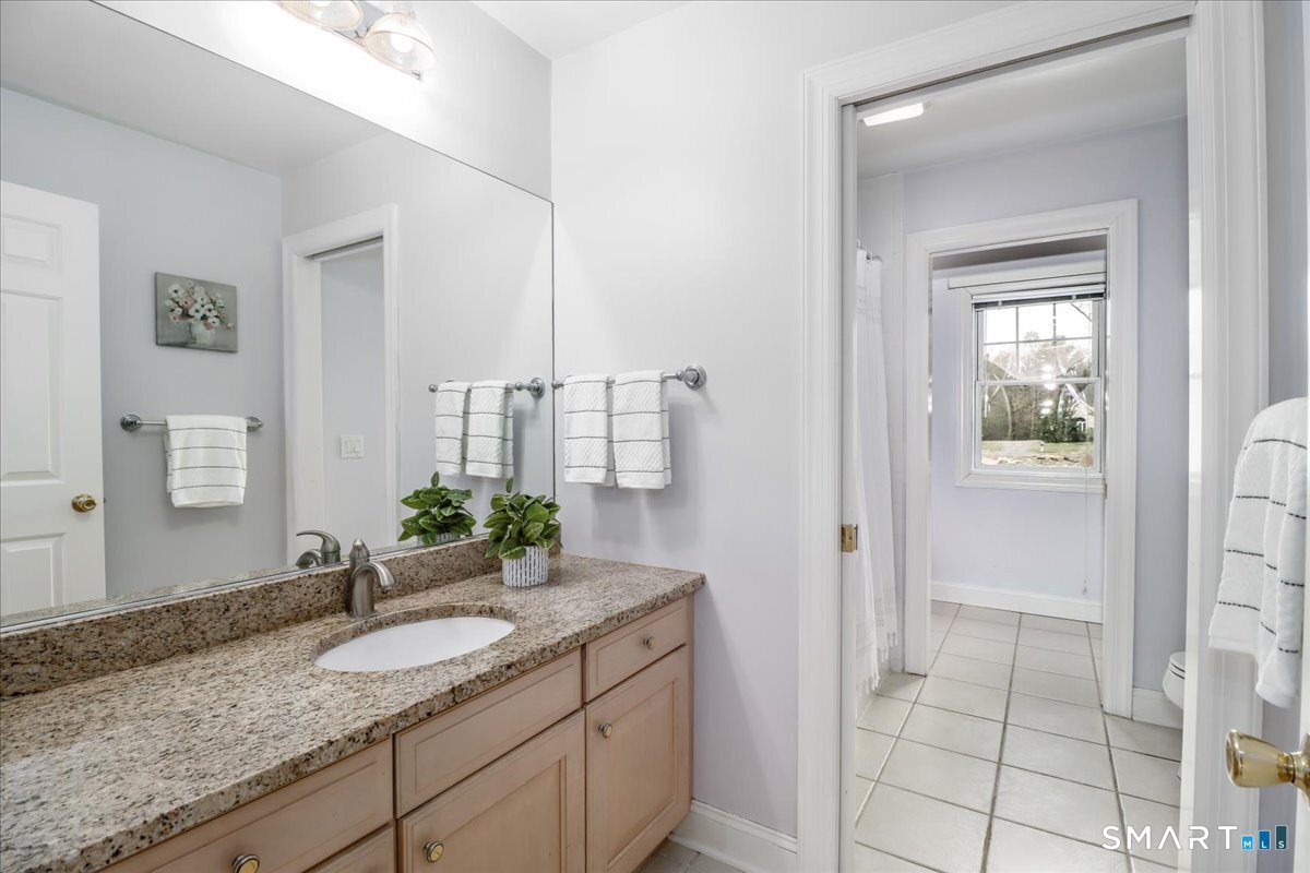 21 Pearl Street Newtown, CT 06482 - Photo 27 of 39 a bathroom with a granite countertop sink and a mirror
