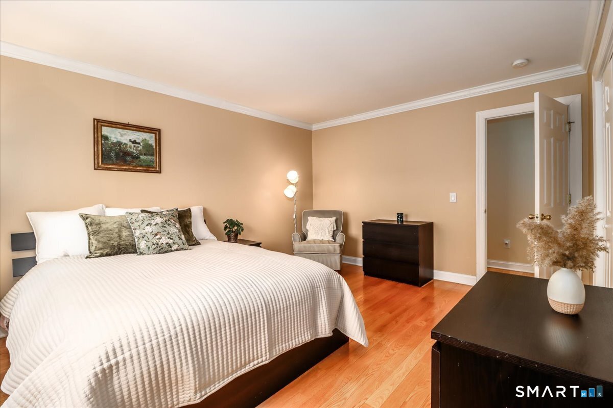 21 Pearl Street Newtown, CT 06482 - Photo 29 of 39 a bedroom with a bed and a table