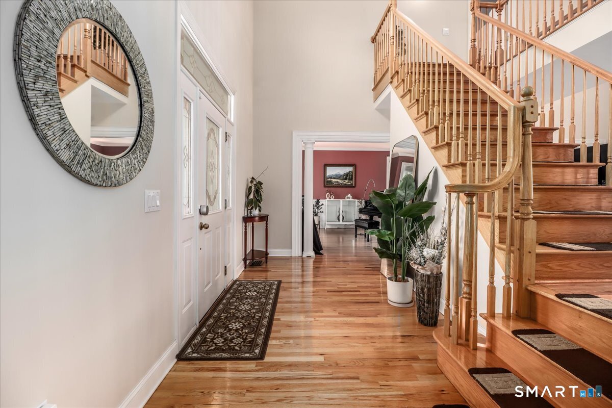 21 Pearl Street Newtown, CT 06482 - Photo 6 of 39 a view of a hallway with wooden floor and a large windows