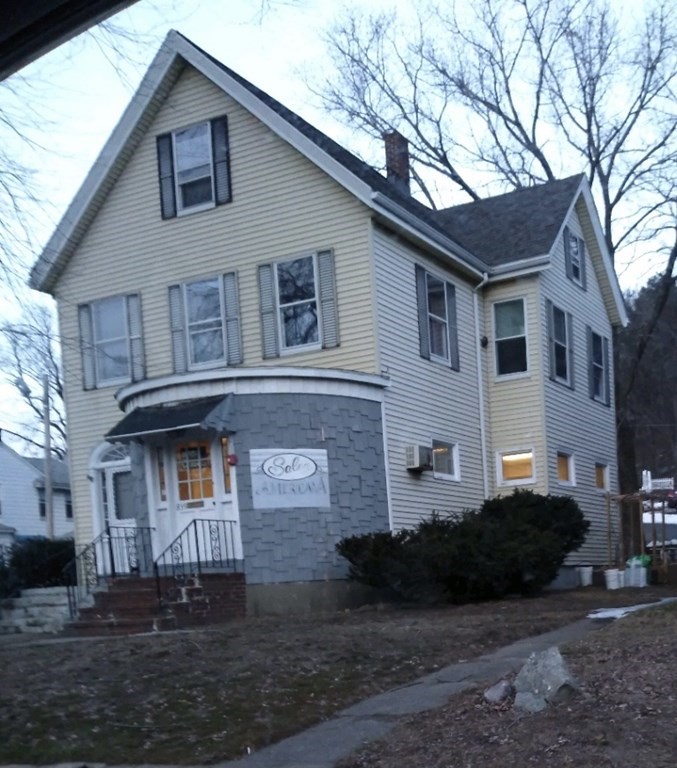 a front view of a house with a yard