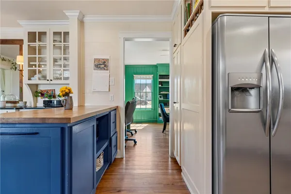 a kitchen with kitchen island a counter top space and a refrigerator