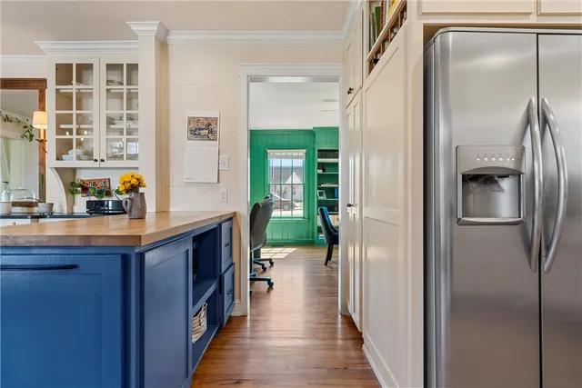 a kitchen with kitchen island a counter top space and a refrigerator