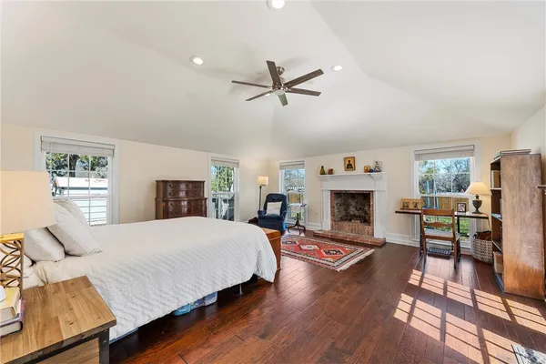 a spacious bedroom with a bed and a fireplace