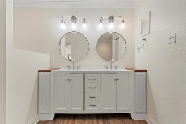 a bathroom with a double vanity sink and a mirror