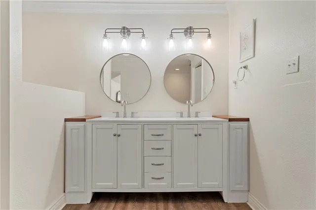 a bathroom with a double vanity sink and a mirror