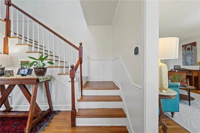 a view of entryway and hall with wooden floor
