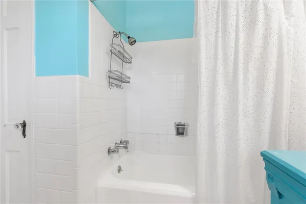 a bathroom with a shower curtain and a sink