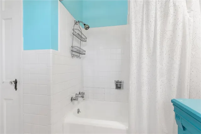 a bathroom with a shower curtain and a sink