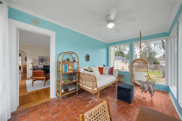 a living room with furniture a rug and a large window