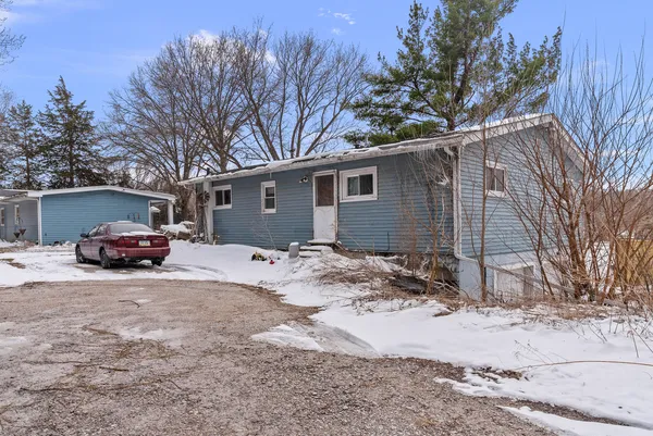 a view of a house with a yard covered in snow
