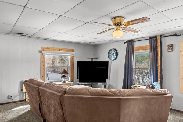 a living room with furniture a window and a flat screen tv